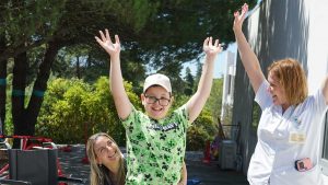criança feliz põe as mãos no ar