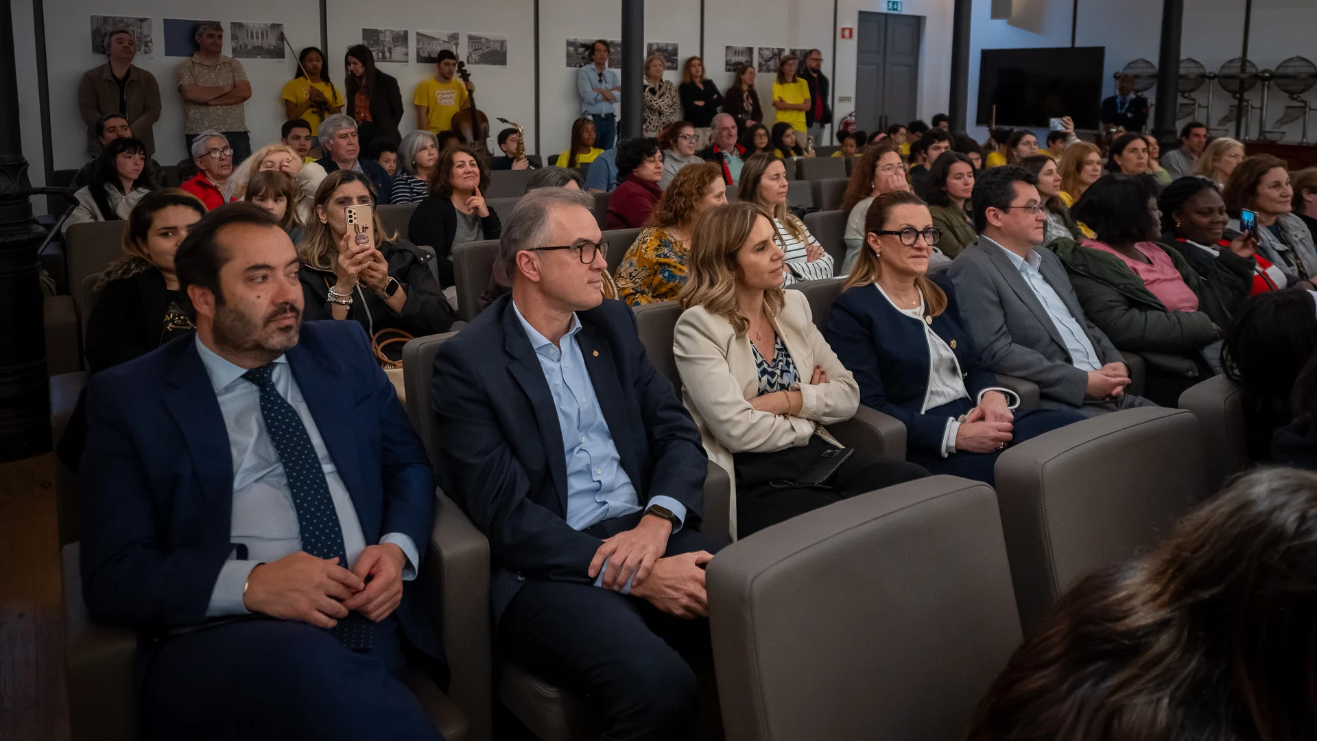 administradores da santa casa assistem ao concerto da orquestra geração na sala de extrações
